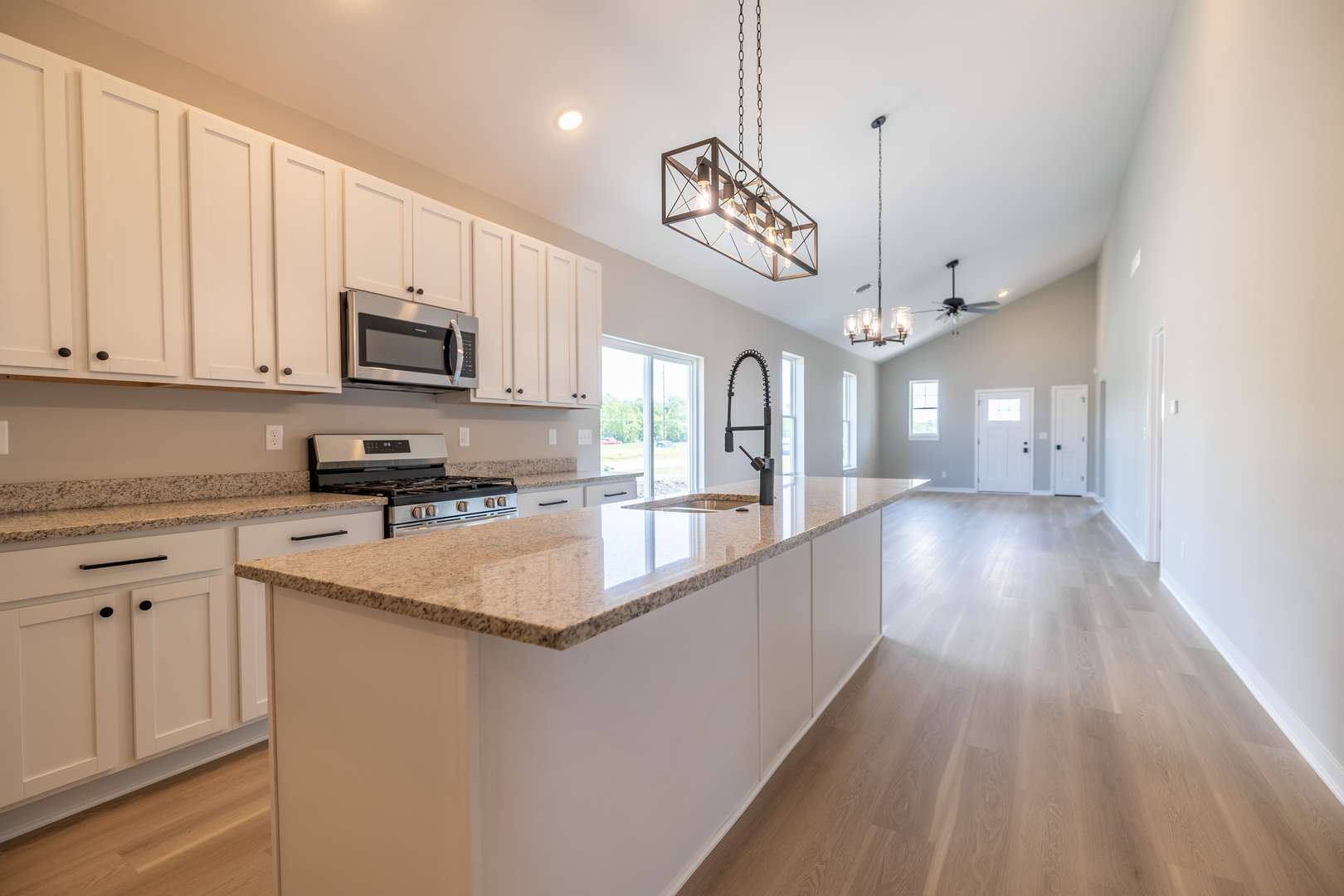 12 Redbud Row Ottawa, IL 61350 - Photo 11 of 39 a large kitchen with stainless steel appliances granite countertop a sink a stove and a wooden floors