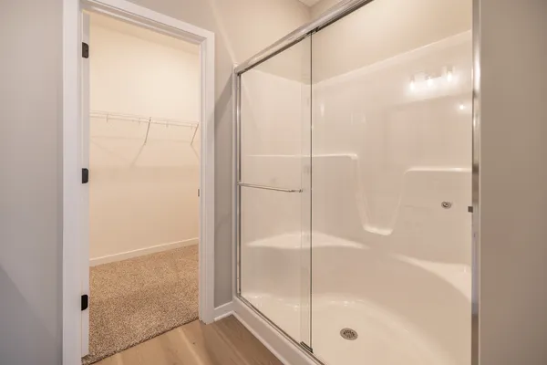 a bathroom with a glass shower door