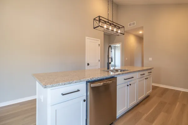 a bathroom with a granite countertop sink a large mirror and a light fixture