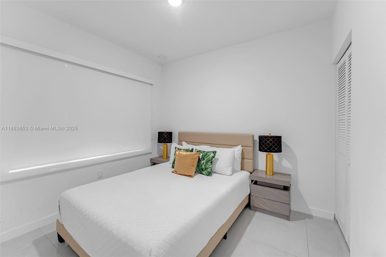 26144 Southwest 146th Court Homestead, FL 33032 - Photo 11 of 35 a bedroom with a bed and window