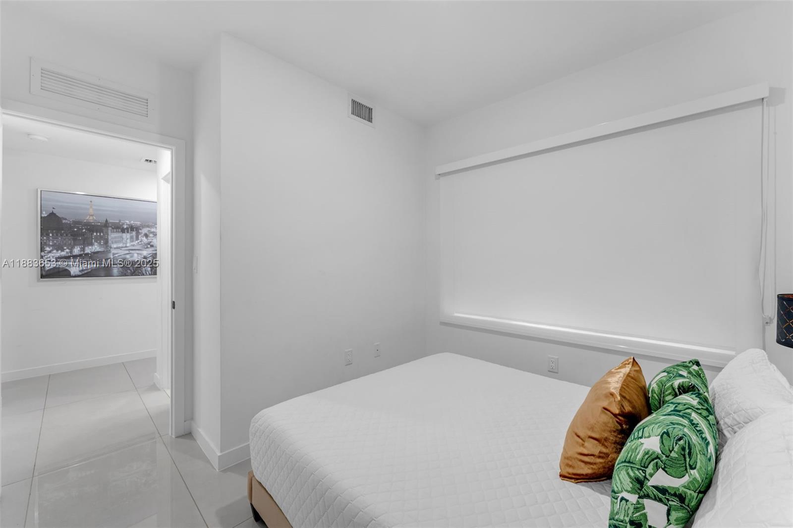 26144 Southwest 146th Court Homestead, FL 33032 - Photo 12 of 35 a bedroom with a bed and a painting on the wall