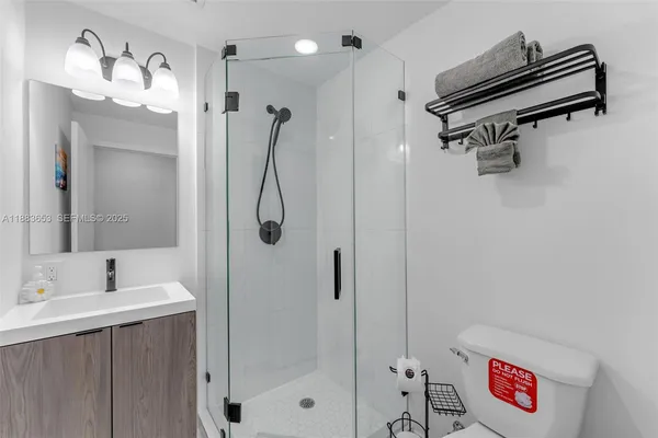 a bathroom with a shower sink and mirror
