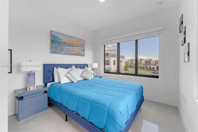 a bedroom with a bed and a large window