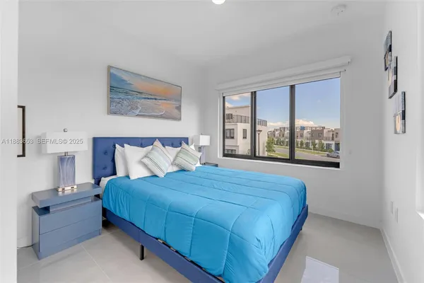 a bedroom with a bed and a large window