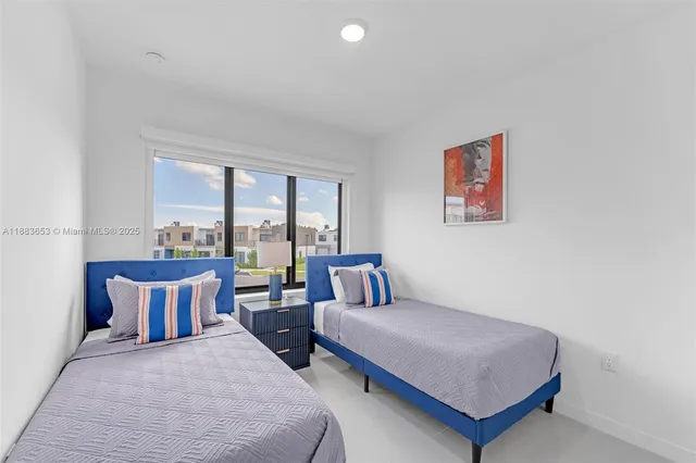 a spacious bedroom with a bed and glass window
