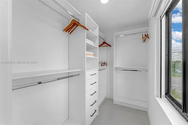 a view of walk in closet with empty racks