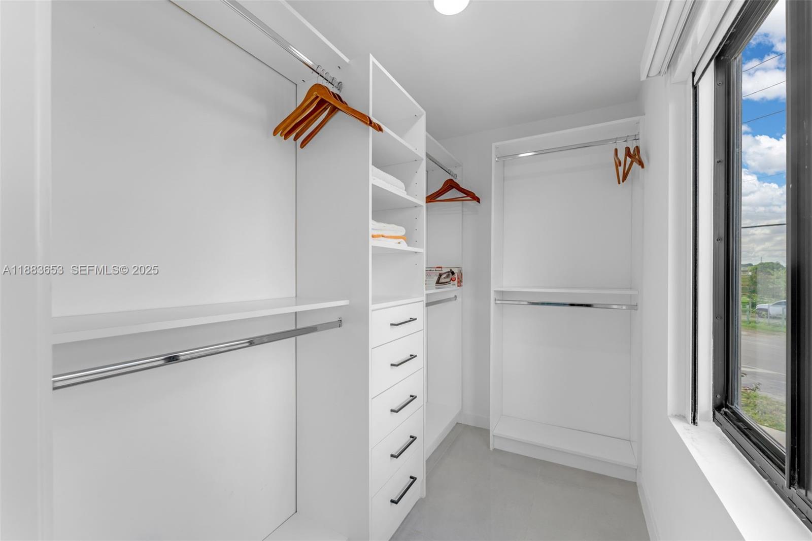 26144 Southwest 146th Court Homestead, FL 33032 - Photo 20 of 35 Custom walk-in closet with built-in organizers and natural light.