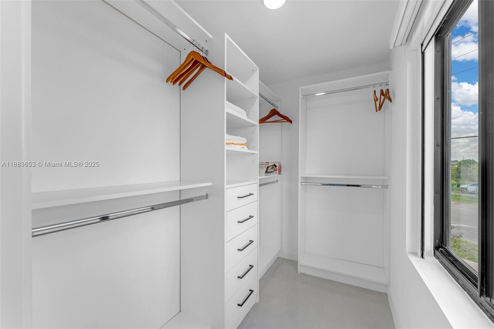 26144 Southwest 146th Court Homestead, FL 33032 - Photo 20 of 35 a view of walk in closet with empty racks