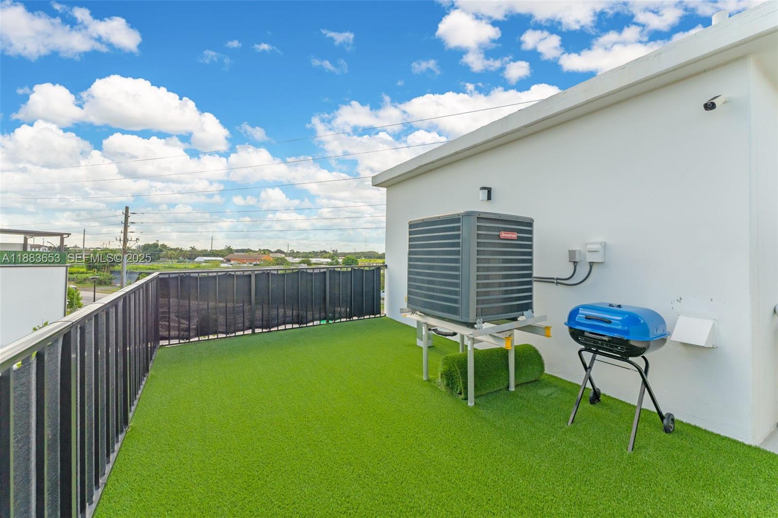 26144 Southwest 146th Court Homestead, FL 33032 - Photo 25 of 35 Back area of rooftop with artificial grass, perfect for BBQ or relaxation.
