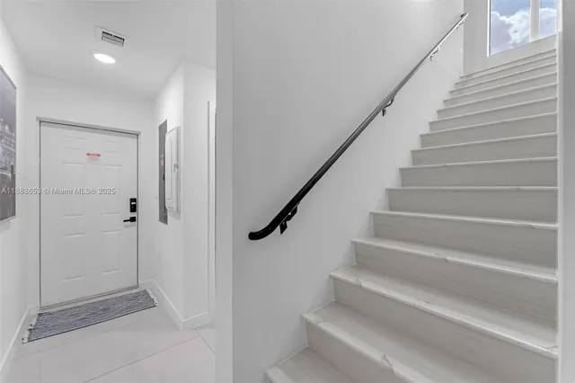 a view of entryway with wooden floor and stairs