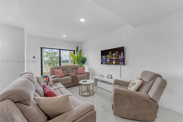 a living room with furniture and a large window