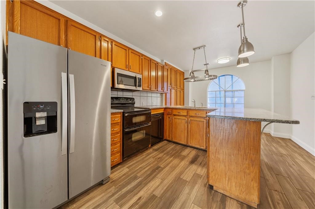 741 Snug Corpus Christi, TX 78402 - Photo 11 of 40 a kitchen with granite countertop a refrigerator a sink and dishwasher