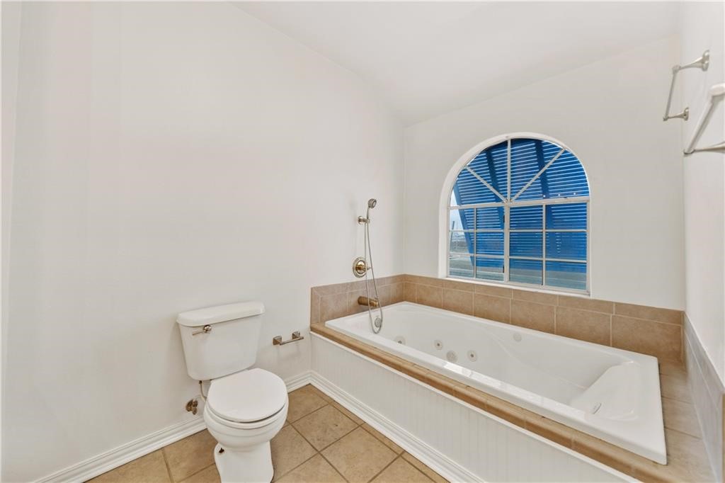 741 Snug Corpus Christi, TX 78402 - Photo 20 of 40 a bathroom with a bathtub and a window