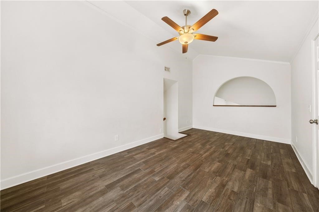 741 Snug Corpus Christi, TX 78402 - Photo 25 of 40 an empty room with wooden floor and a ceiling fan