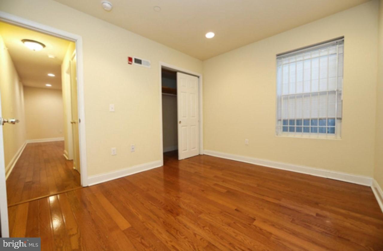 1708 West Diamond Street, Unit B Philadelphia, PA 19121 - Photo 13 of 20 an empty room with wooden floor and windows