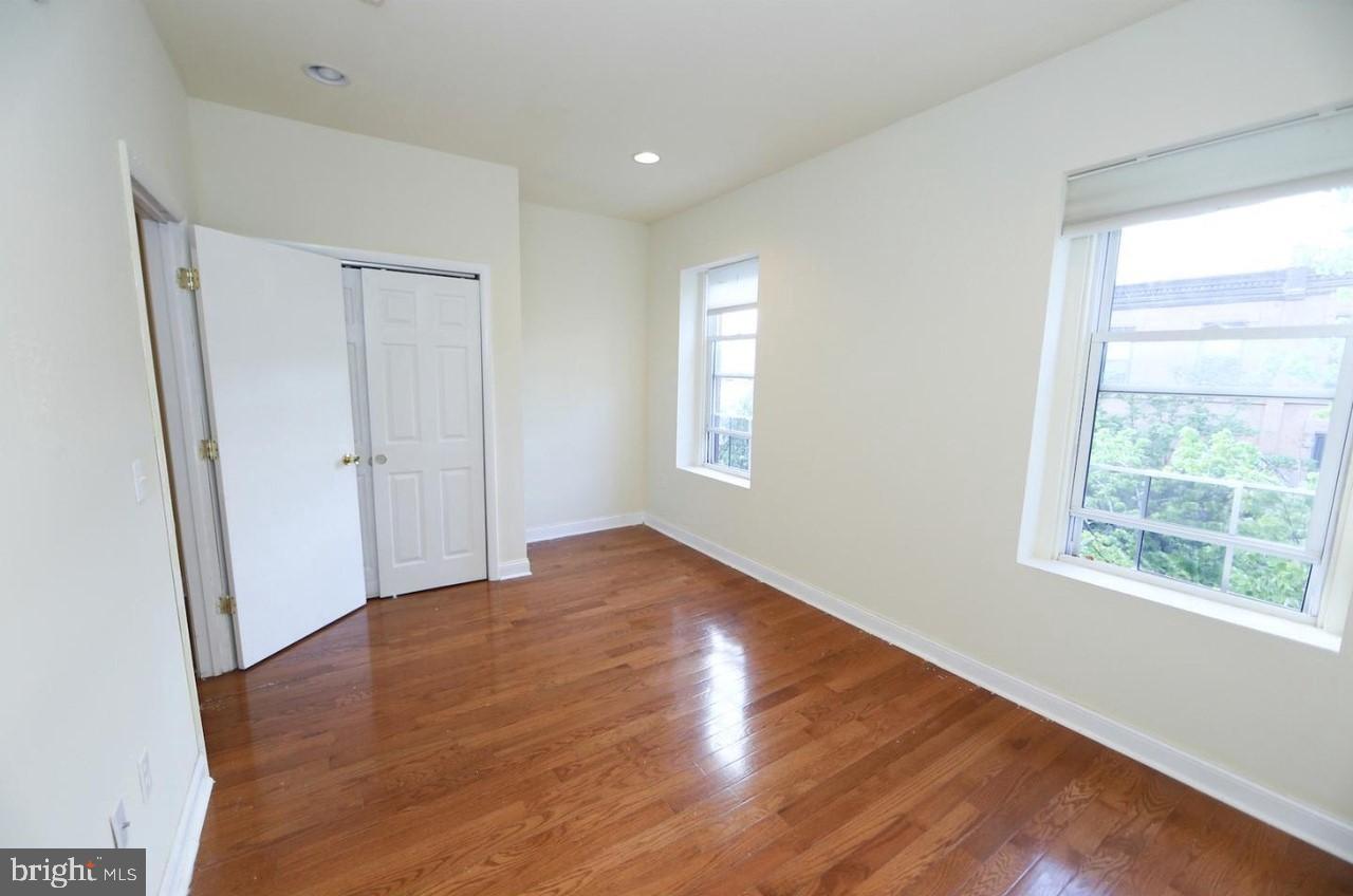 1708 West Diamond Street, Unit B Philadelphia, PA 19121 - Photo 15 of 20 a view of empty room with wooden floor and fan