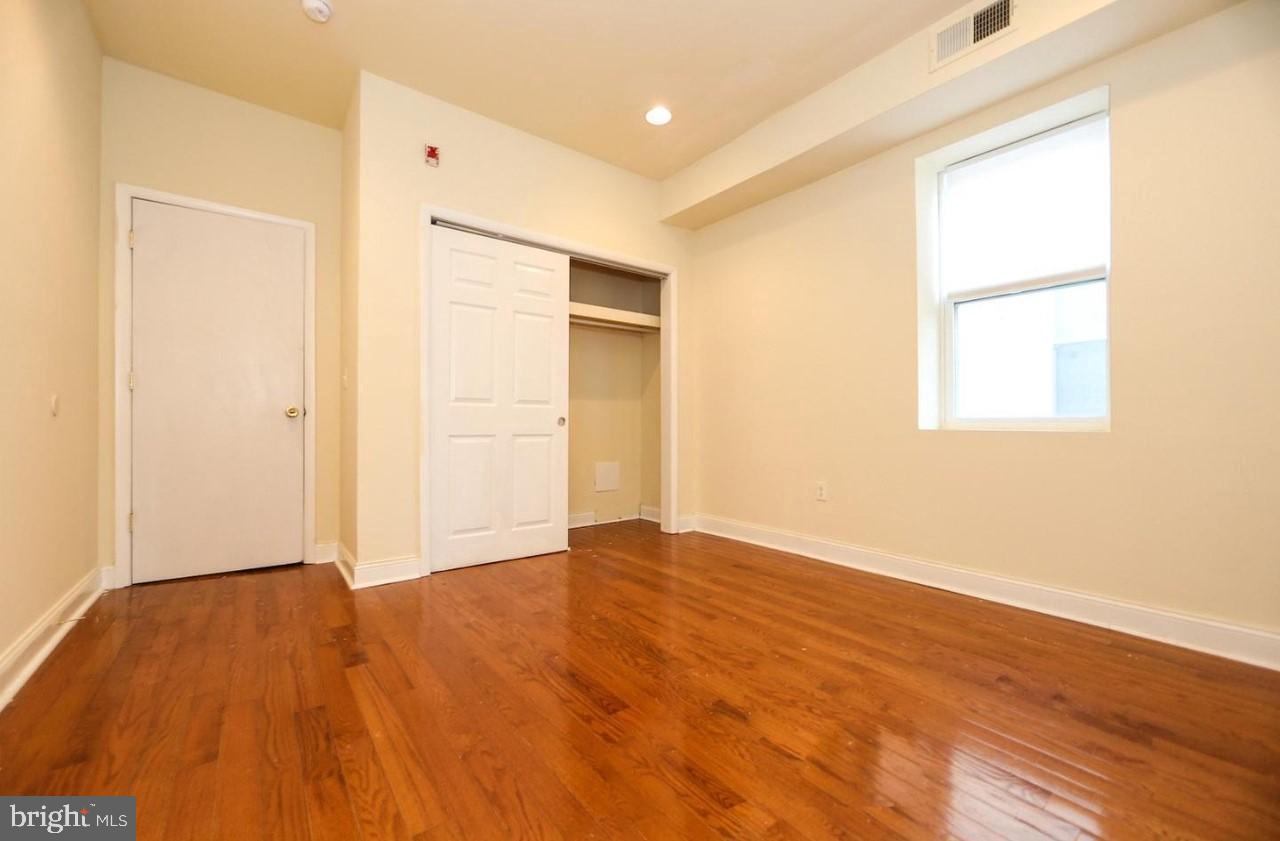 1708 West Diamond Street, Unit B Philadelphia, PA 19121 - Photo 17 of 20 an empty room with wooden floor and a window