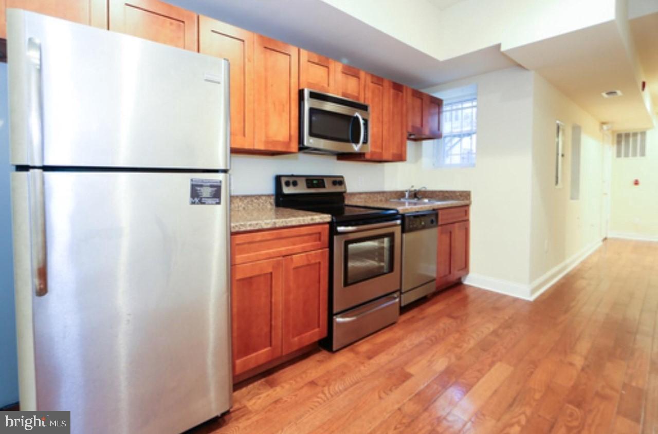 1708 West Diamond Street, Unit B Philadelphia, PA 19121 - Photo 3 of 20 a kitchen with stainless steel appliances granite countertop a refrigerator a stove a sink and a microwave