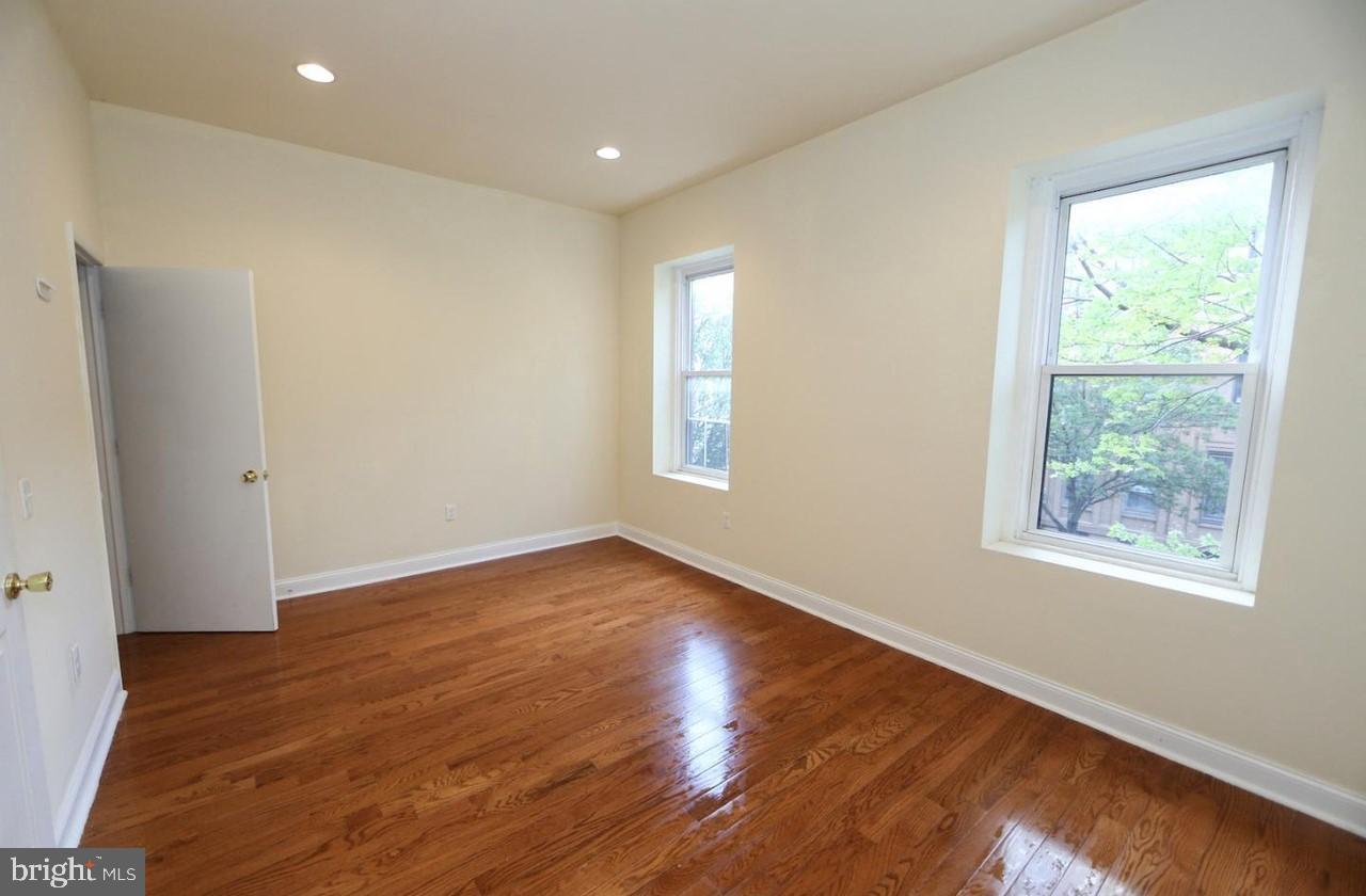 1708 West Diamond Street, Unit B Philadelphia, PA 19121 - Photo 6 of 20 a view of an empty room with wooden floor and a window