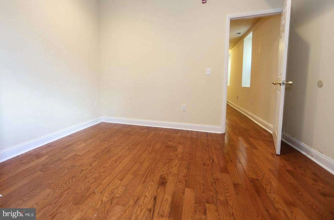 1708 West Diamond Street, Unit B Philadelphia, PA 19121 - Photo 7 of 20 an empty room with wooden floor and closet