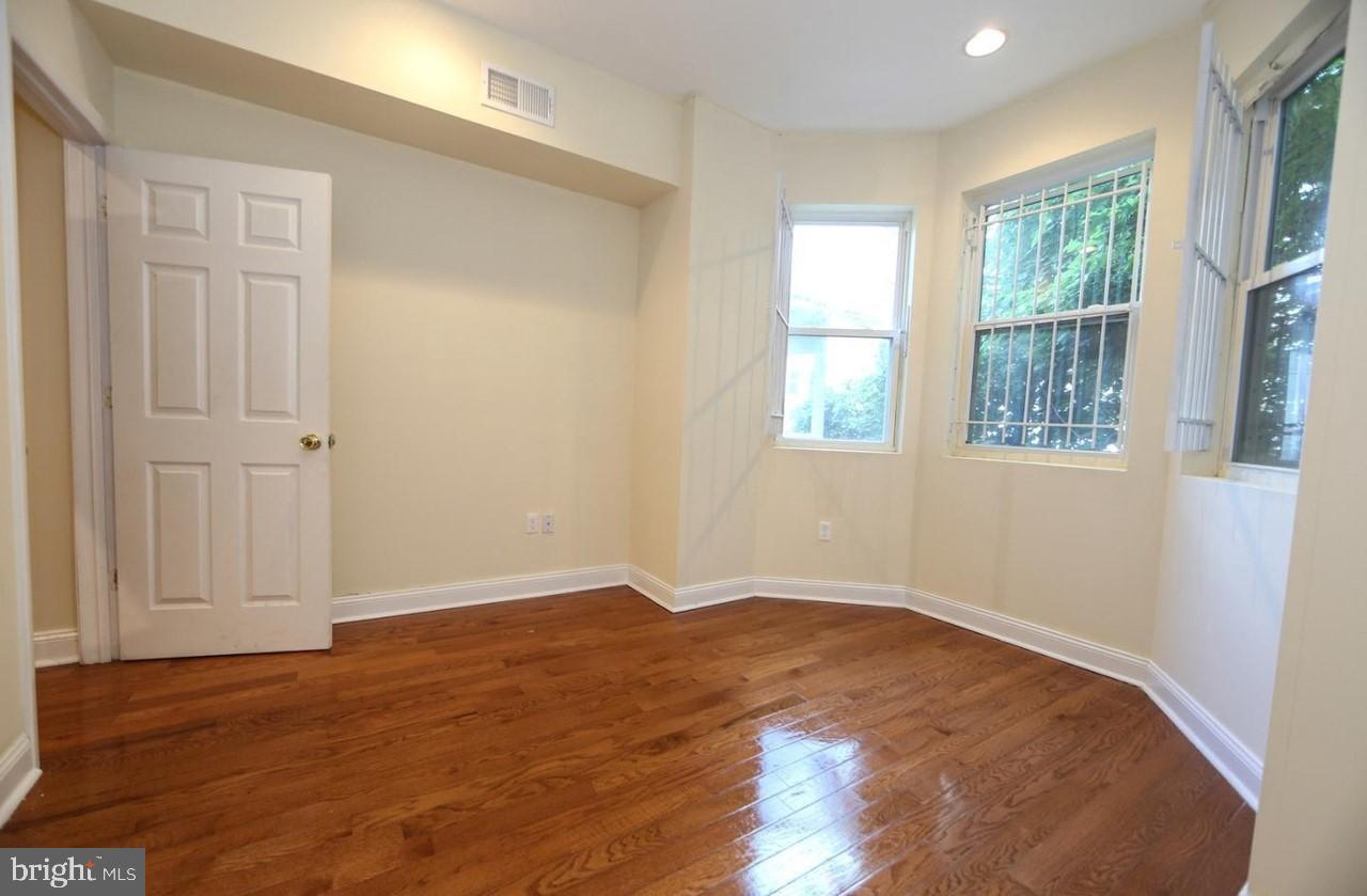 1708 West Diamond Street, Unit B Philadelphia, PA 19121 - Photo 8 of 20 an empty room with wooden floor and windows