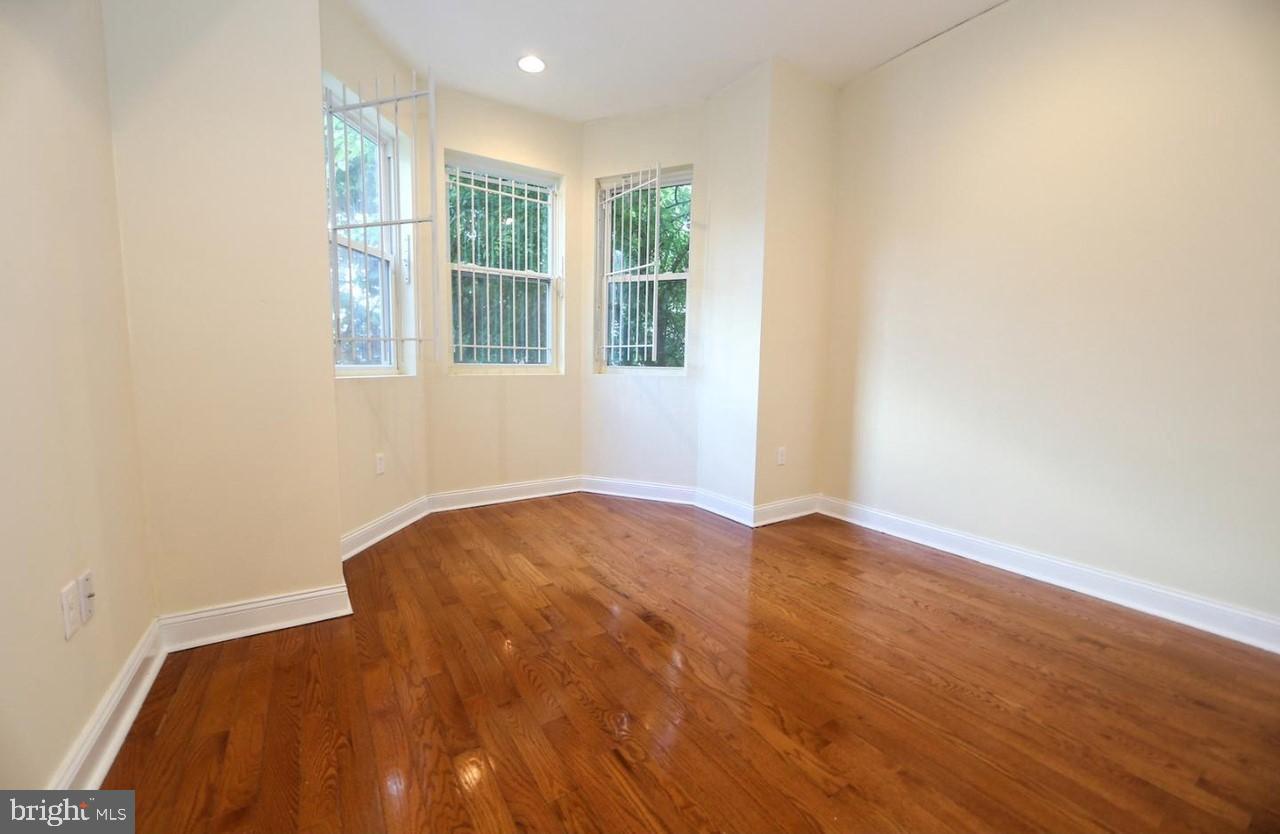 1708 West Diamond Street, Unit B Philadelphia, PA 19121 - Photo 9 of 20 an empty room with wooden floor and windows