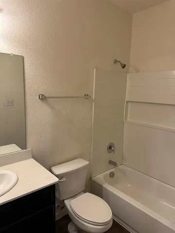 a bathroom with a toilet a sink and bathtub