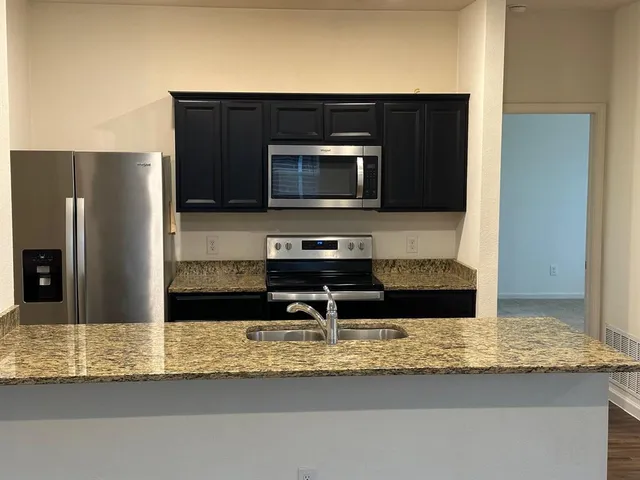 a kitchen with a sink and a window