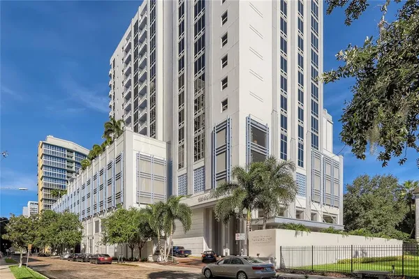 a front view of a multi story building with yard