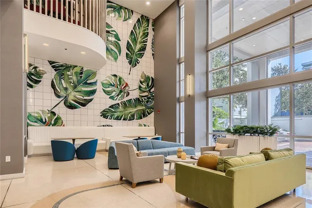 a living room with furniture and a potted plant