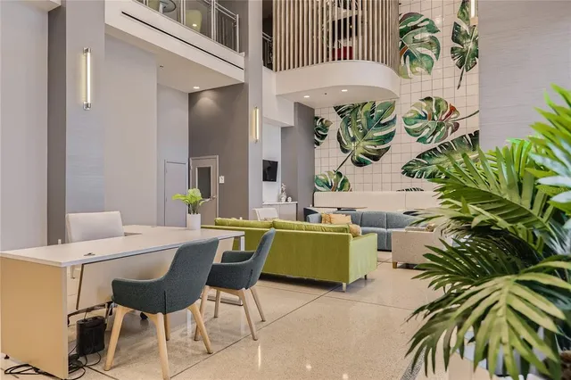 a living room with furniture and a potted plant