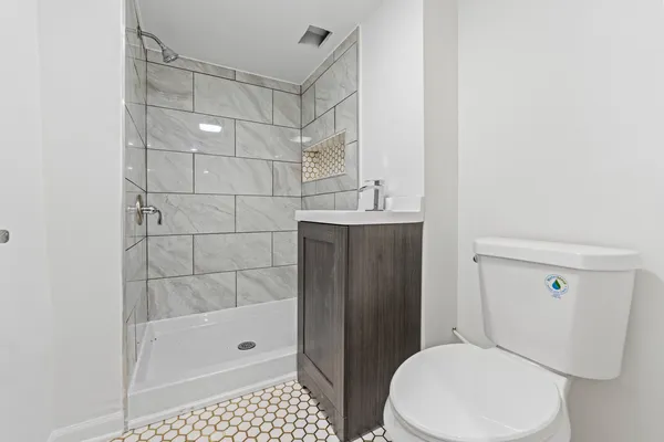 a view of empty room with fireplace and wooden floor