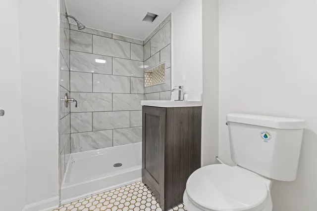 a view of empty room with fireplace and wooden floor