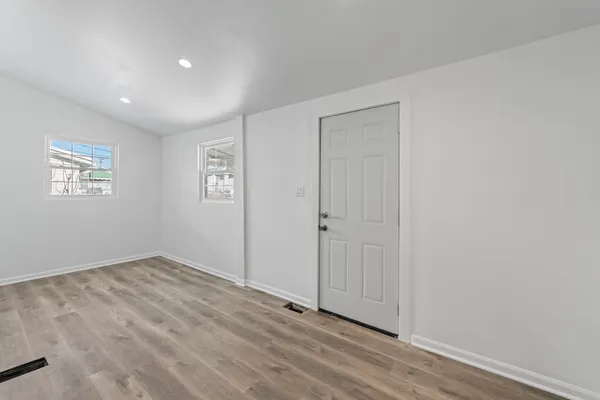 a kitchen with white cabinets and appliances