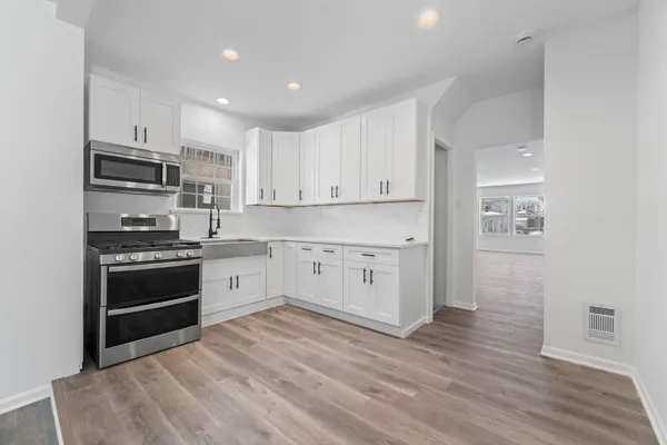 a view of a kitchen with wooden floor
