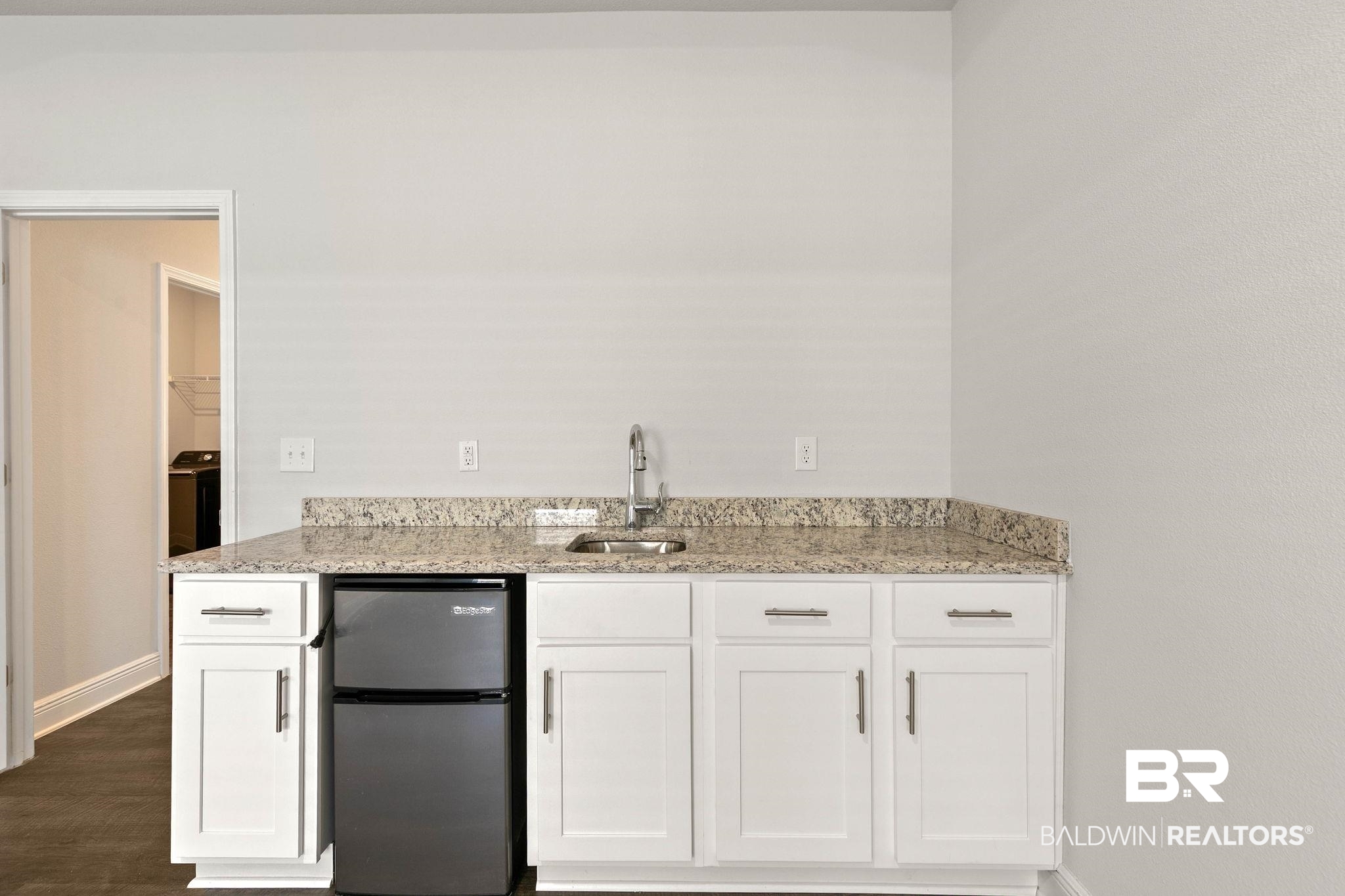 9448 Amethyst Drive Daphne, AL 36526 - Photo 41 of 61 Kitchen with light stone countertops, white cabinets, and freestanding refrigerator