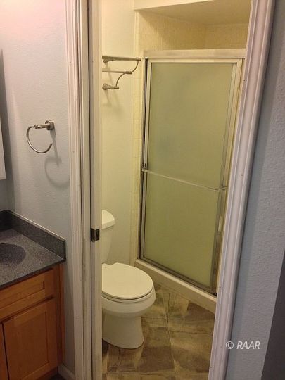 1224 North Erwin Street Ridgecrest, CA 93555 - Photo 23 of 30 a bathroom with a granite countertop toilet and a sink