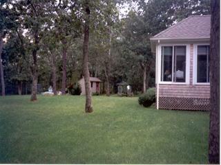 Undisclosed Address Barnstable, MA 02630 - Photo 3 of 6 a view of a house with a backyard
