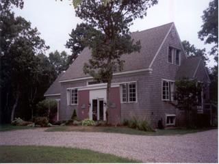 Undisclosed Address Barnstable, MA 02630 - Photo 4 of 6 front view of a house with a yard