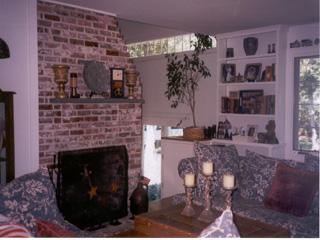 Undisclosed Address Barnstable, MA 02630 - Photo 5 of 6 a living room with furniture a table and a fireplace