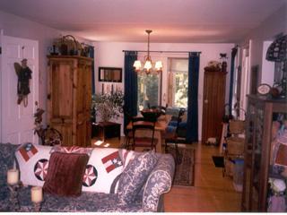 Undisclosed Address Barnstable, MA 02630 - Photo 6 of 6 a living room with furniture and a chandelier