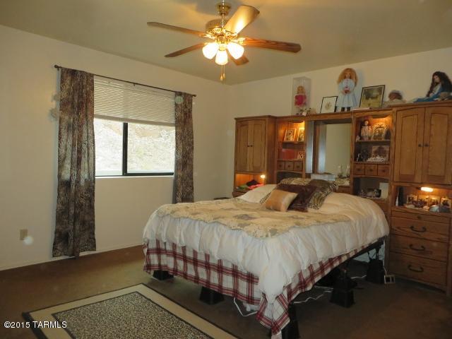 963 Calle Amarillo Rio Rico, AZ 85648 - Photo 6 of 31 a bedroom with a bed and a chandelier
