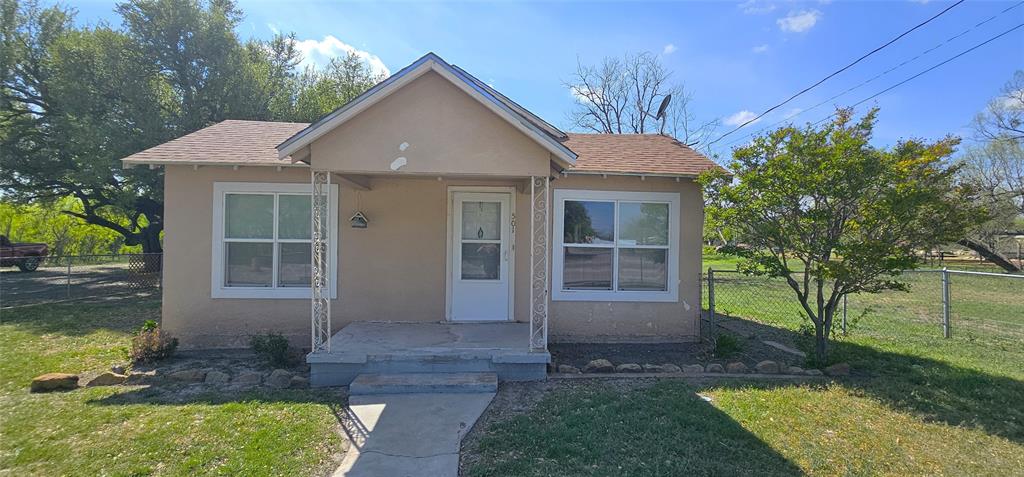 501 South Main Street Eden, TX 76837 - Photo 1 of 20 a front view of a house with garden