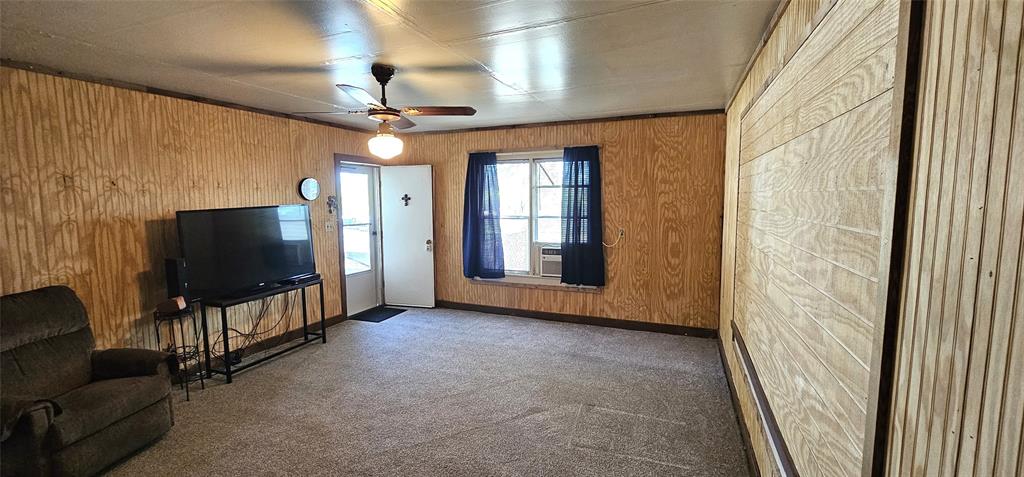 501 South Main Street Eden, TX 76837 - Photo 9 of 20 a view of livingroom with furniture flat screen tv and windows