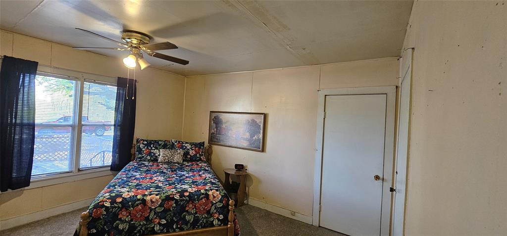 501 South Main Street Eden, TX 76837 - Photo 10 of 20 a bedroom with a bed and a lamp with window
