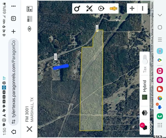 an aerial view of residential house and car parked on side of road