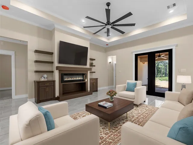 a living room with furniture a flat screen tv and a fireplace