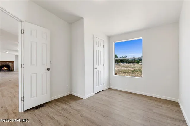 a bathroom with a double vanity sink and mirror with bathtub