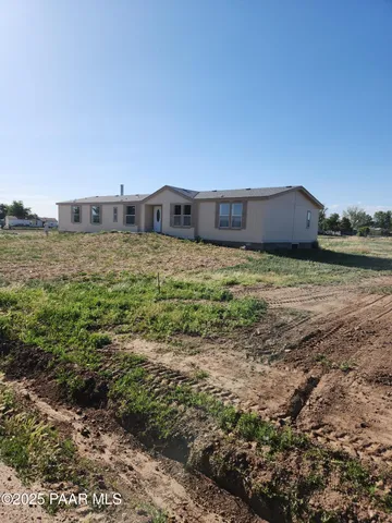 a large kitchen with stainless steel appliances granite countertop a refrigerator a stove top oven a sink and dishwasher with wooden floor