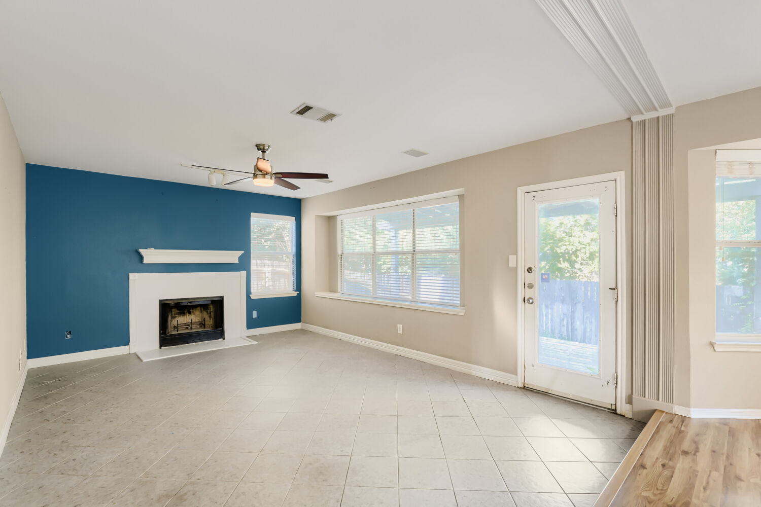 17204 Village Glen Road Pflugerville, TX 78660 - Photo 8 of 19 Living room with blue accent wall & fireplace